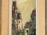 an oil painting of a street scene in a frame on a wall