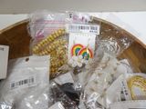 a wooden bowl filled with jewelry and other items