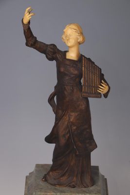 statue of a woman holding a musical instrument on a marble base