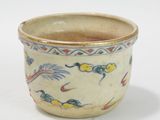 a small cup with a bird design on it