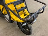 a yellow scooter that is parked in a garage