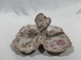 a small white plate with a flower on it