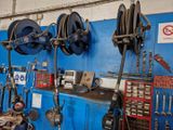 a blue wall with a bunch of tools hanging on it