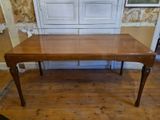 a wooden table that is sitting on a hard wood floor