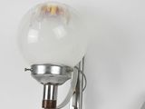 a light that is on the wall next to a pair of scissors