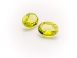 a pair of yellow sapphires on a white background