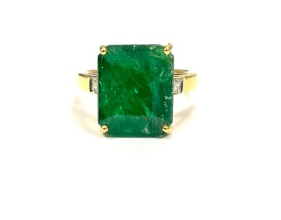 an emerald and diamond ring on a white background