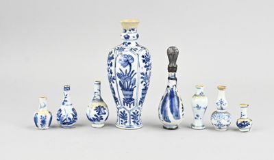 several blue and white vases are arranged in a row on a gray surface