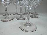 six wine glasses sitting on a table with a white background