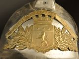 a silver helmet with a gold emblem on it