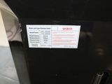 an image of a black refrigerator with a warning sticker on it