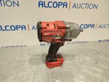 a red cordless drill is sitting on top of a table