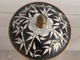 a black and white plate with a flower design on it