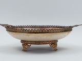 a large silver and gold bowl on a stand