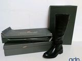 a pair of black boots and a box on a table
