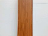 a wooden speaker that is sitting on a white surface