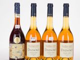 trois bouteilles de vin sont posées les unes à côté des autres sur une surface blanche