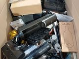 a cardboard box filled with assorted electronic devices