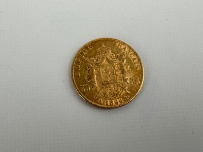 a close up of a gold coin on a white surface