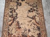 an old rug with a picture of a forest scene on it