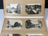 an old photo of a book opened to show pictures of a town