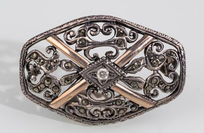 a close up of a silver and gold ring on a white surface