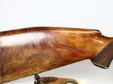 an image of a rifle with a wooden barrel on a white background