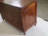 a small wooden chest on a white surface