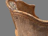 a wicker chair that is sitting on a grey surface