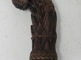a wooden stick with a design on it on a white surface