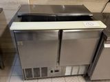 two stainless steel sinks in a kitchen with tile flooring