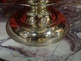 a silver candle that is sitting on a marble table