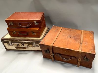 three suitcases stacked on top of each other on a table