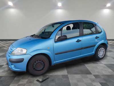 a picture of a small blue car parked in a garage