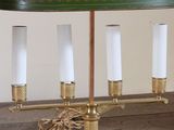 a lamp that is sitting on a table with a green shade