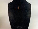 black velvet display case with a necklace and earrings on a white background