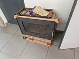 a small stove that has a sign on top of it