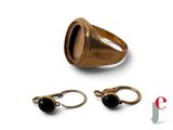 an image of a gold ring with a black stone on it