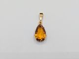 a yellow gold pendant with a tear shaped citrine stone