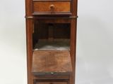 an old wooden cabinet with a drawer on top of it