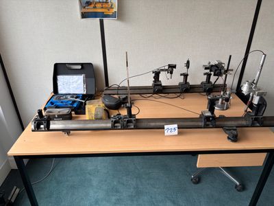 an image of a table with a laptop and a machine
