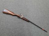 a rifle that is laying on the ground