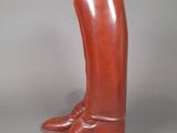 pair of brown leather boots with a banana stuck in them