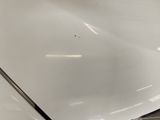 a close up of a car ' s hood with a small hole in the hood