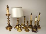 a lot of candles and a lamp on the table