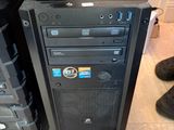 a black computer tower with a monitor on top of it