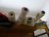 several rolls of toilet paper are sitting on a shelf in a room