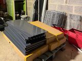 a pile of black plastic sheets on a pallet