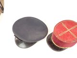two hats sitting next to each other on a white surface