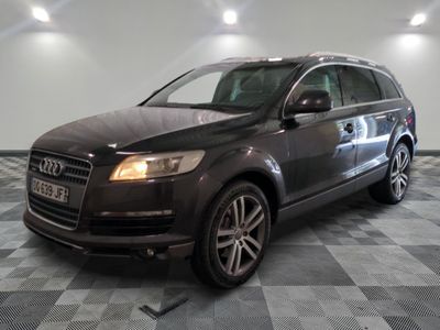 une photo d'un SUV Audi noir garé sur un sol à damier